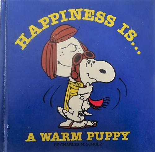 Peanuts - diversen  - Happiness is...A warm puppy, Hardcover (Determined Productions)